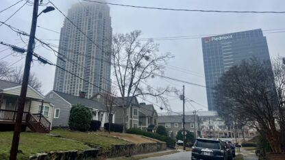 Houses and buildings are shown in an Atlanta neighborhood on a cloudy day