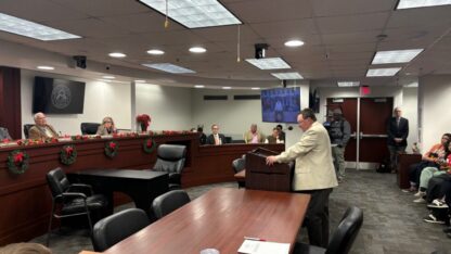 Randy Beall stands at a podium in front of the Georgia Public Service Commission.