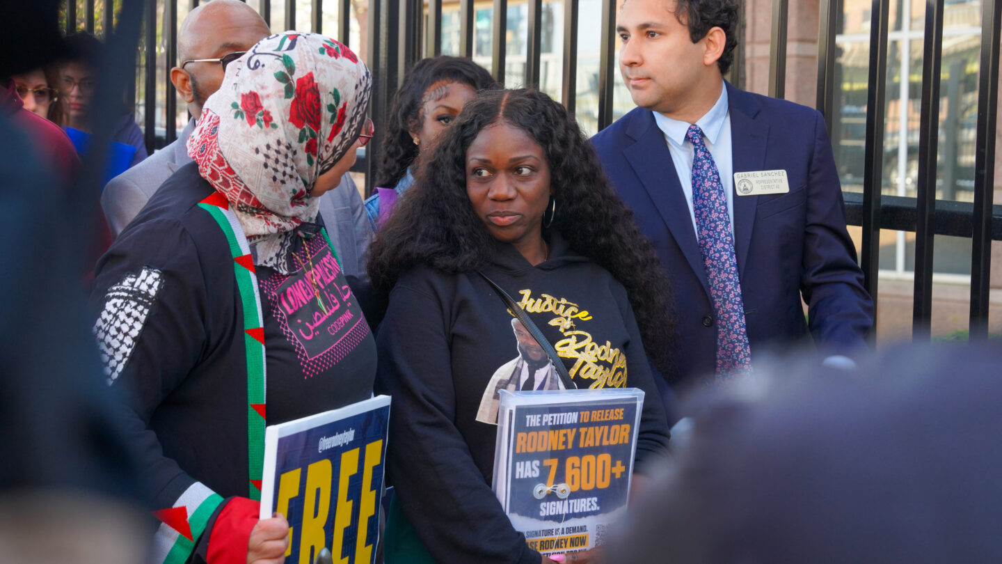 Mildred Taylor stands in between state representatives.
