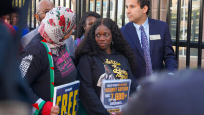 Mildred Taylor stands in between state representatives.