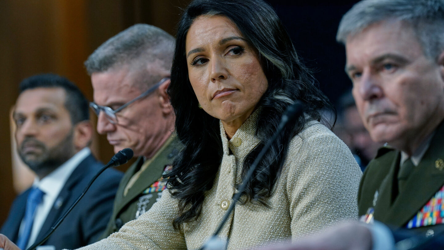 Kash Patel, James Adams, Tulsi Gabbard, William Hartman sit in a row at a congressional hearing.
