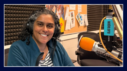 Meghna Chakrabarti sits in front of a WABE microphone at the studio