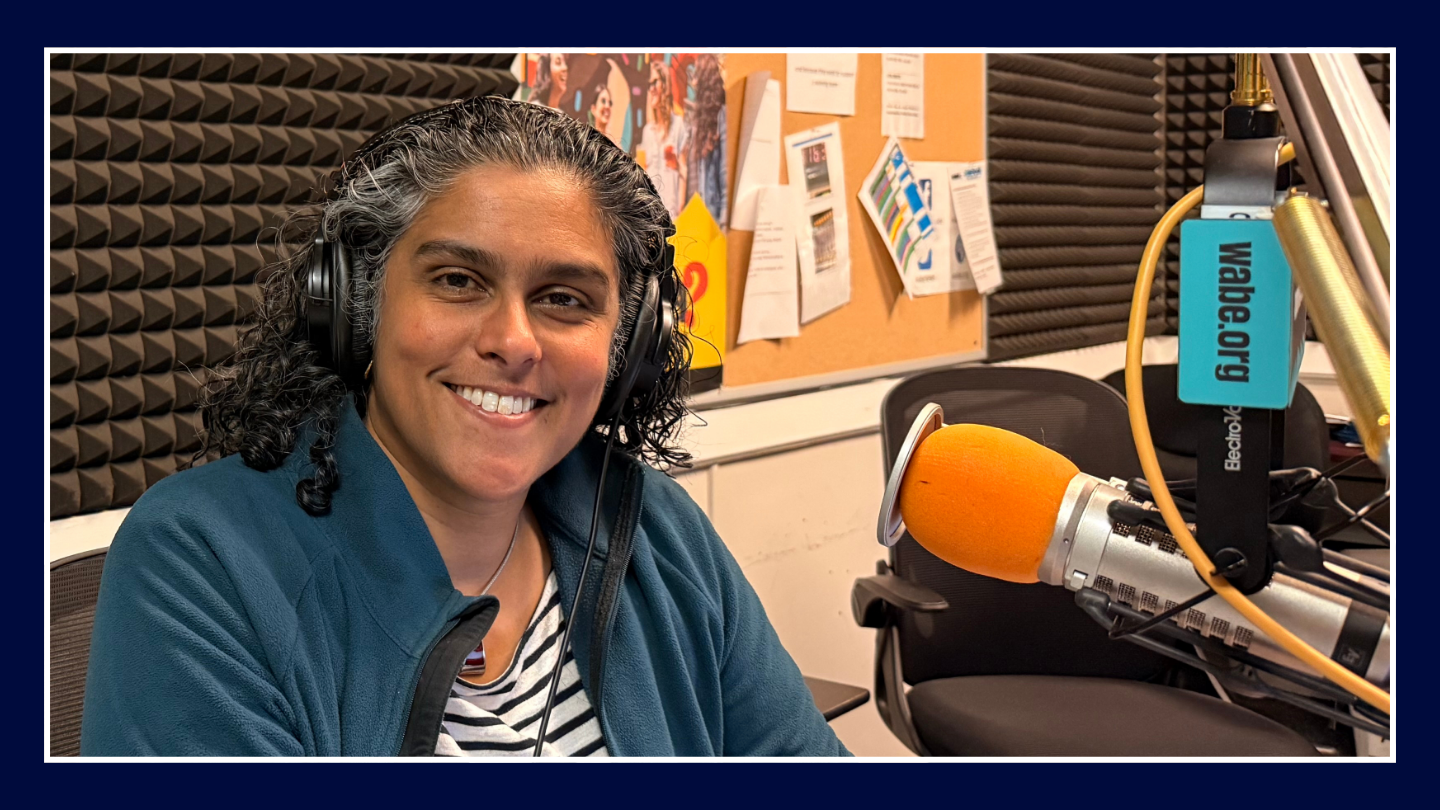 Meghna Chakrabarti sits in front of a WABE microphone at the studio