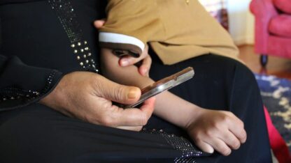 A hand holds a phone