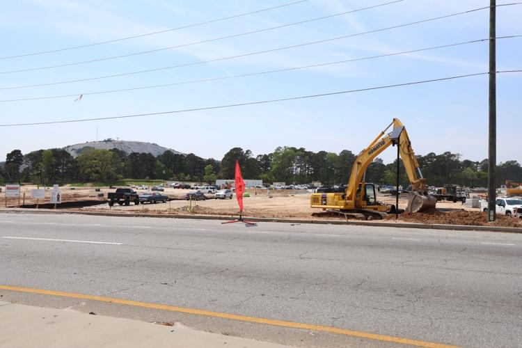 A large piece of undeveloped land with a construction crew