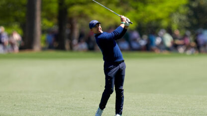A golf player hits a golf ball