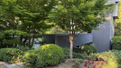Four story Tree House at 231 DeGress Avenue in Inman Park Atlanta surrounded by lush trees and garden shrubs
