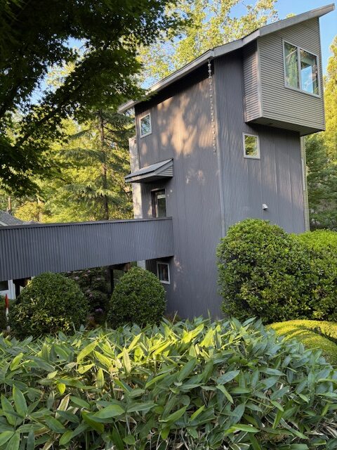 Four story Tree House at 231 DeGress Avenue in Inman Park Atlanta surrounded by lush trees and garden shrubs