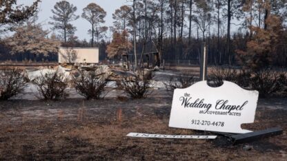 Burned remains with an intact wedding chapel sign.
