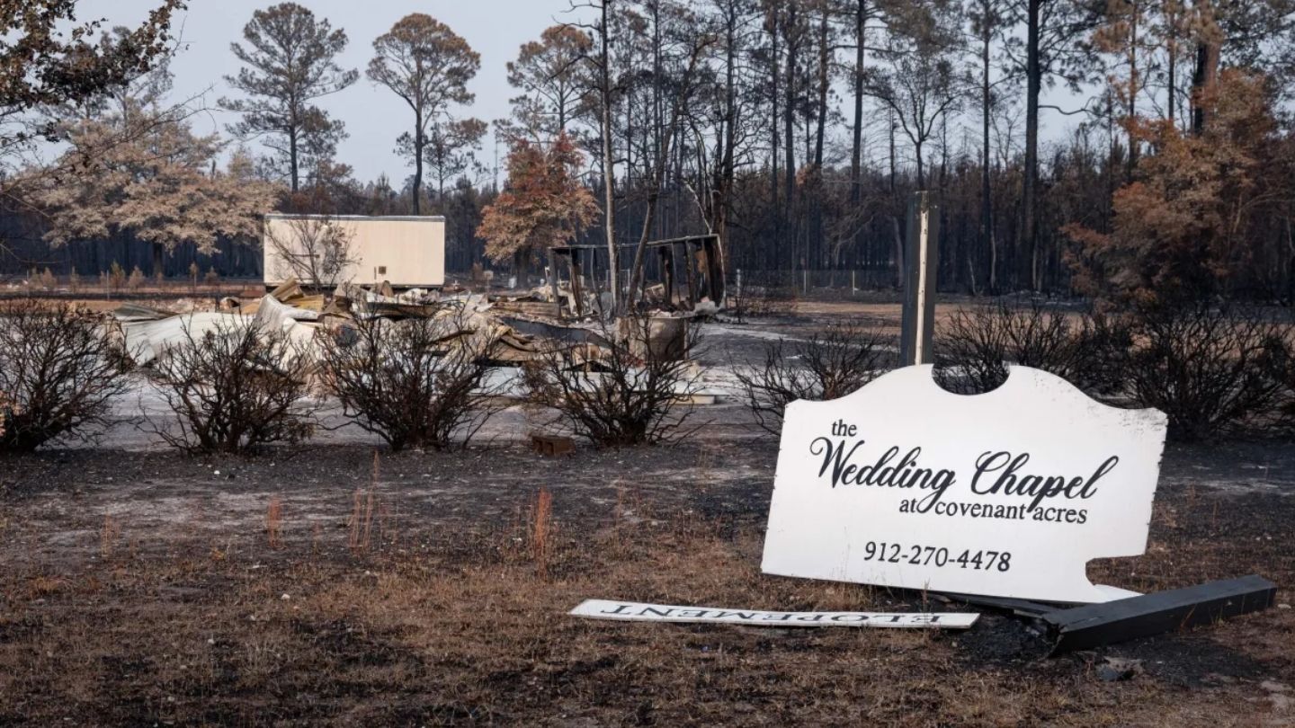 Burned remains with an intact wedding chapel sign.