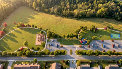 Rendering of a grassy field along a road with trails, a pickleball court, a playground, and other park amenities. This rendering was shown in a YouTube video by DeKalb County.