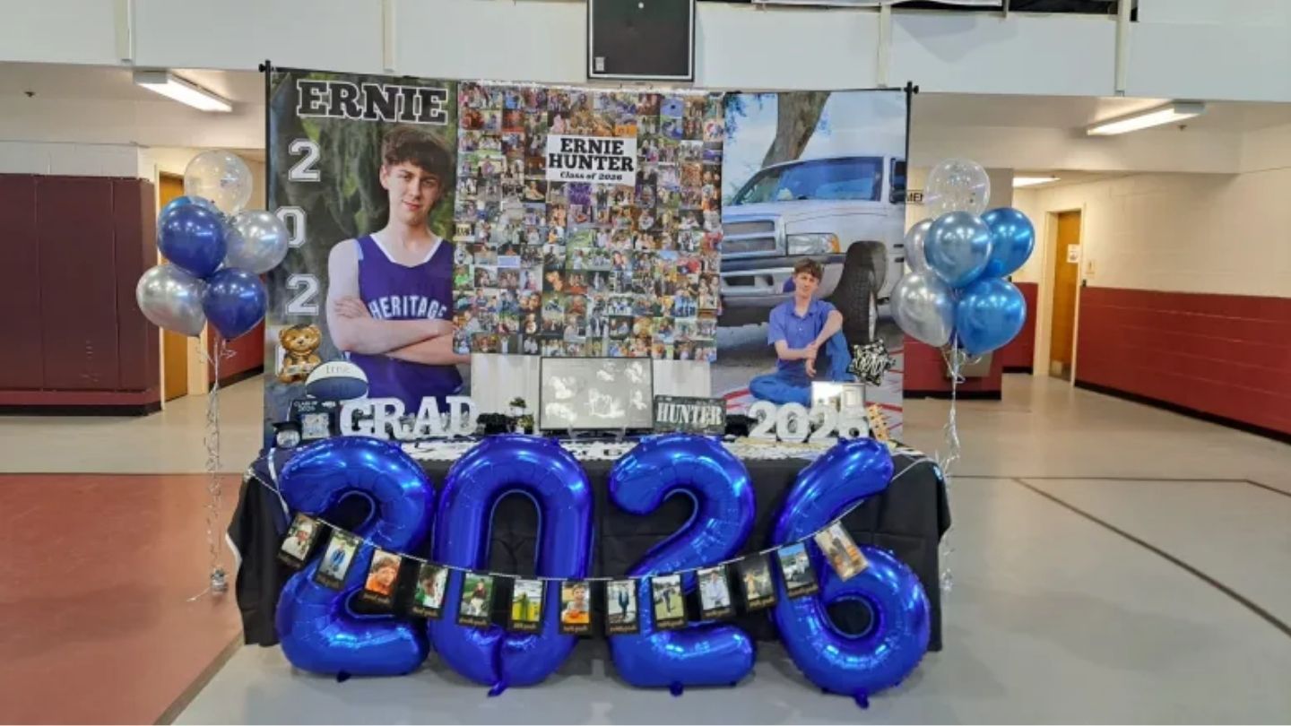 a graduation table with photos and balloons.