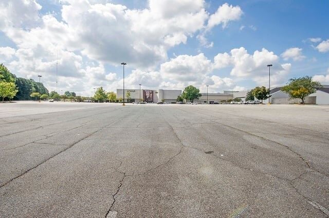 An empty parking lot under a cloudy day