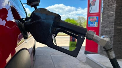 A pump fills up the tank of a vehicle at an Exxon gasoline station