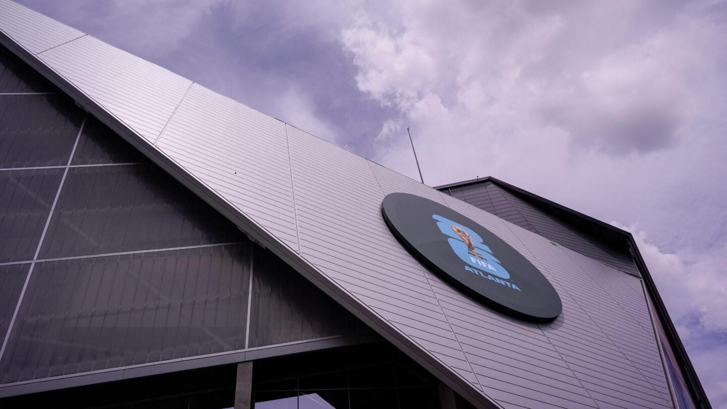 The triangular side of a silver stadium with a circle on it containing FIFA World Cup branding