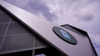 The triangular side of a silver stadium with a circle on it containing FIFA World Cup branding