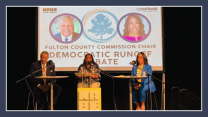 A man, a woman, and another woman wearing a blue pantsuit sit in front of a projected screen with the words Fulton County Commission Chair Democratic runoff debate.