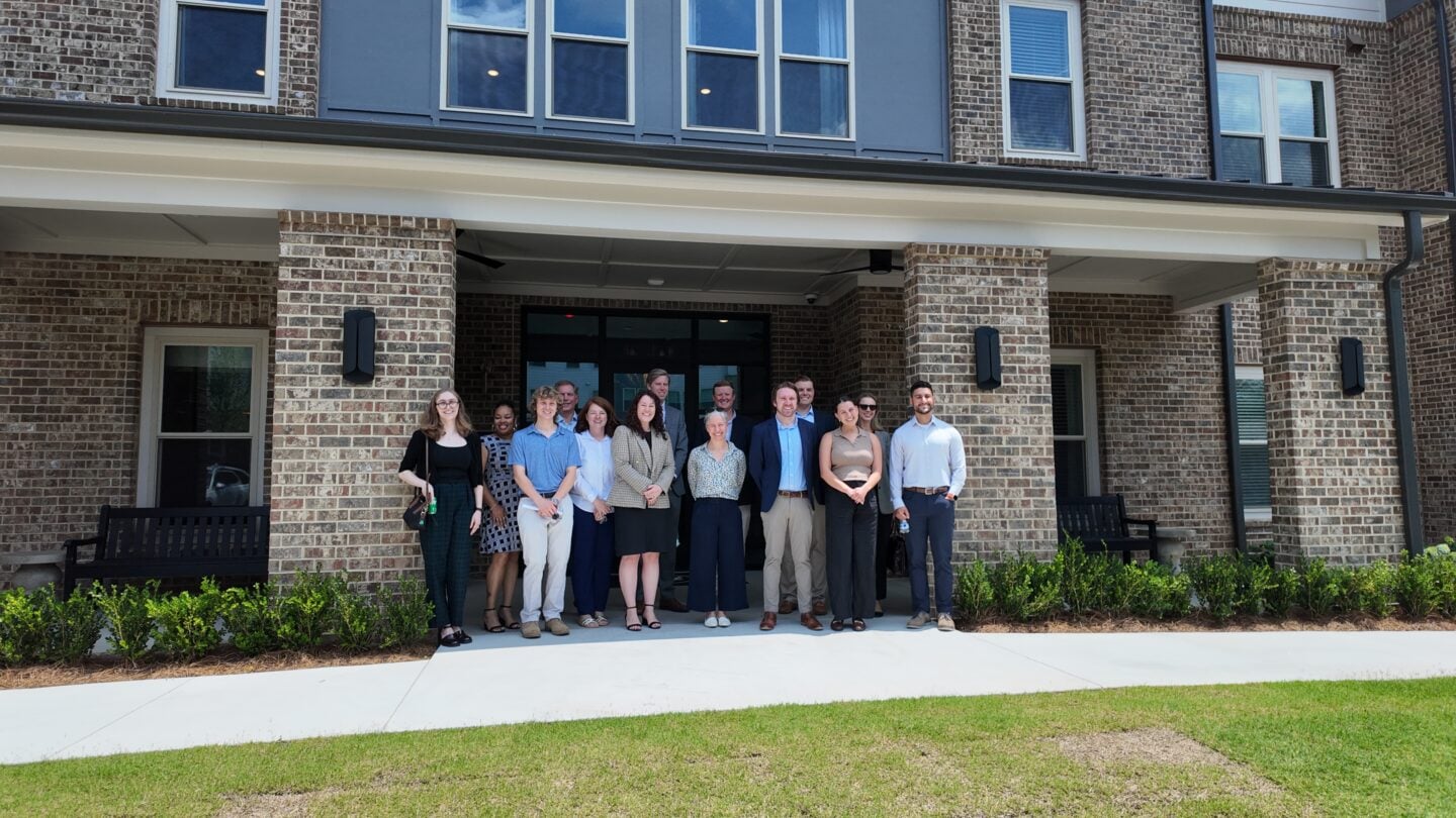A group of people standing in front of a building.