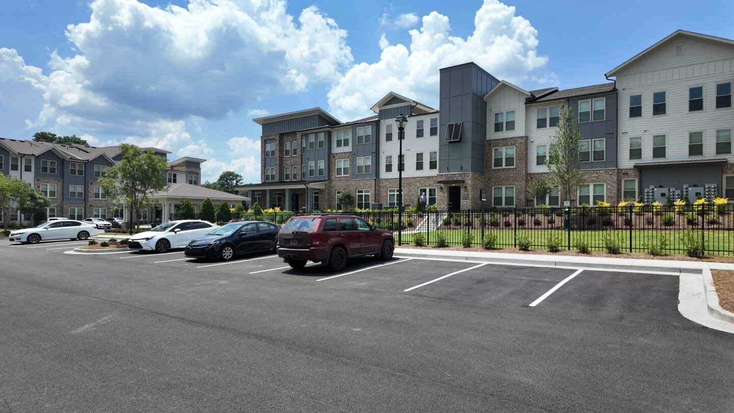 A set of apartment buildings with a parking lot