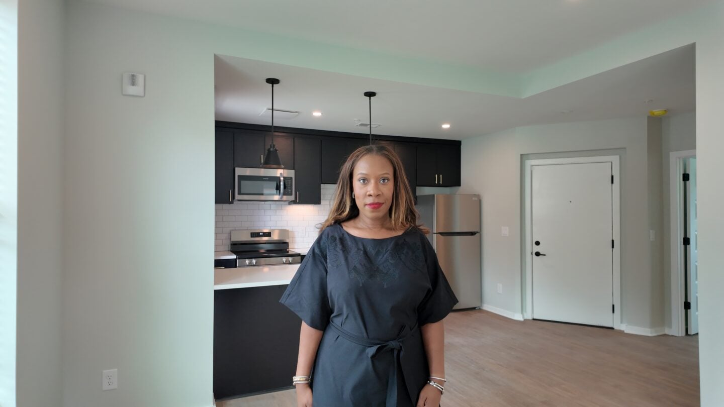 A woman standing in an apartment.