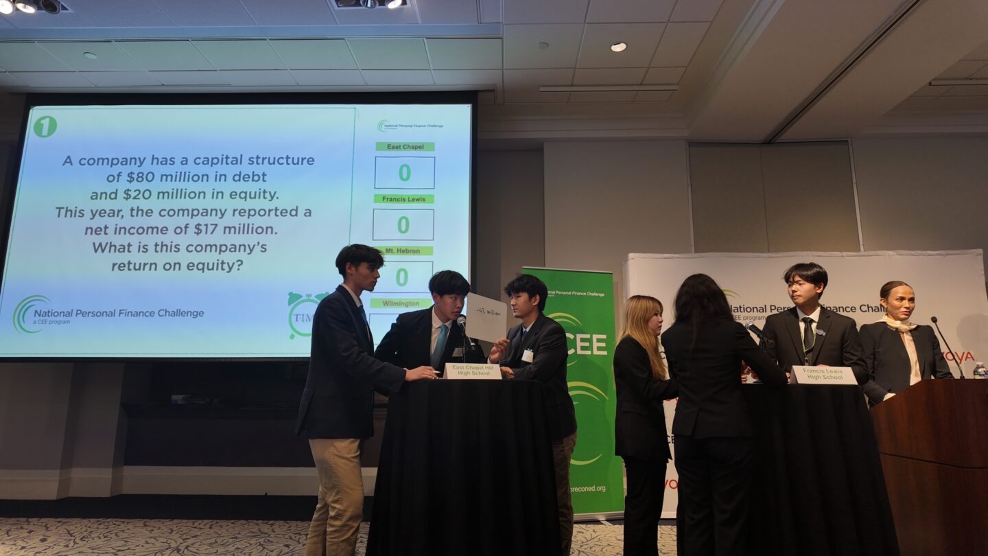 A group of high schoolers scramble to answer financial questions correct.