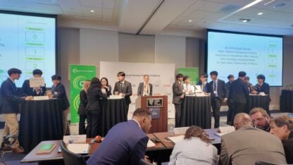 Students scramble to answer questions while judges discuss.