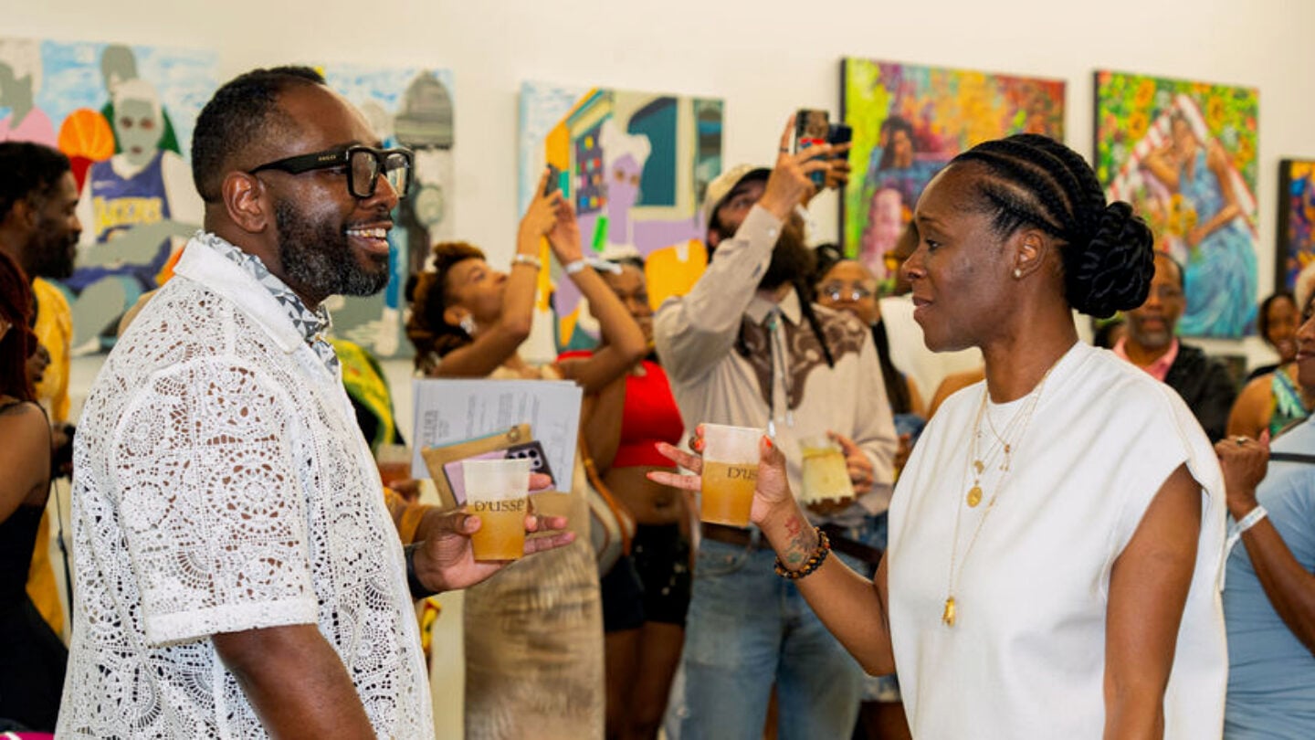 Several people stand in an art gallery