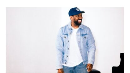 A man wearing a baseball cap looks to the right