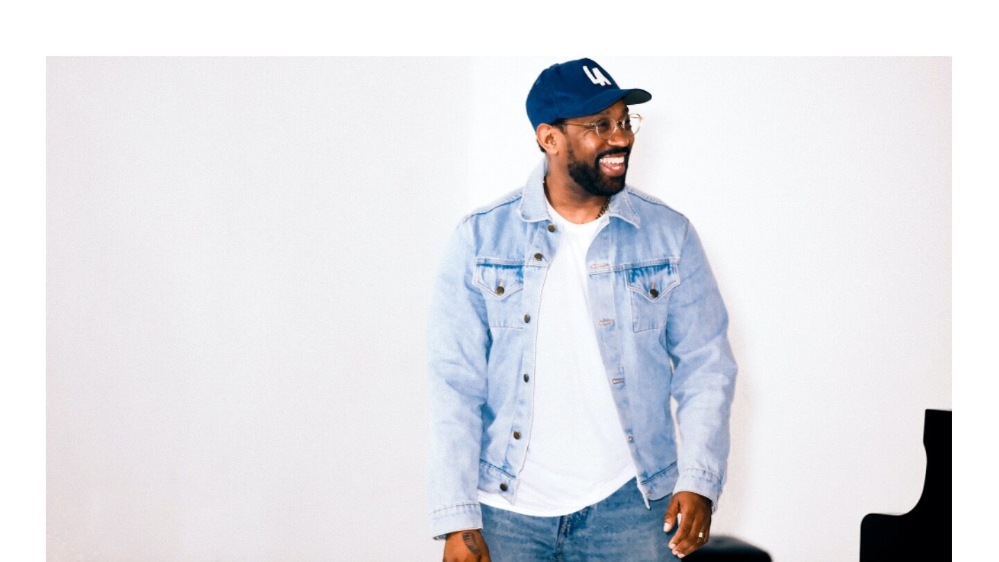 A man wearing a baseball cap looks to the right