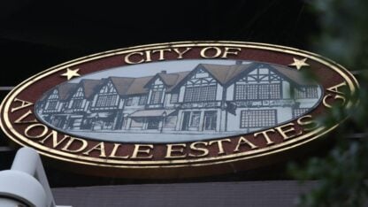 An oval sign that says City of Avondale Estates
