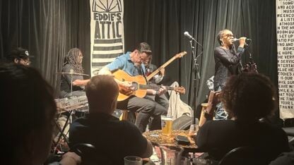 Musicians and a singer perform on stage during an Atlanta Storytellers ‘Songs That Shape Us’ show at Eddie’s Attic